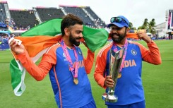 Virat Kohli and Rohit Sharma celebrate with the trophy after winning the ICC men's Twenty20 World Cup 2024 final cricket match between India and South Africa 