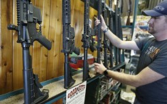 Dordon Brack pulls a semi-automatic AR-15 off the rack at Good Guys Guns & Range on February 15, 2018 in Orem, Utah