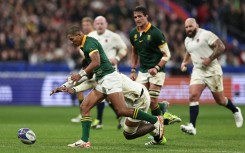 Manie Libbok (L) seeks possession for South Africa in a 2023 Rugby World Cup semi-final victory over England in Paris