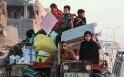 Displaced Palestinians leave an area of Khan Yunis after the Israeli army issued a new evacuation order, which the UN called the largest since the Israel-Hamas war began