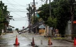 Cars line up outside a gas station after the passage of Beryl in Freeport, Texas