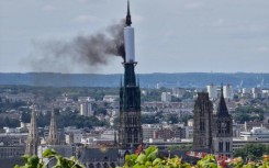 Smoke billows from the spire of Rouen Cathedral in Rouen, northern France on July 11, 2024