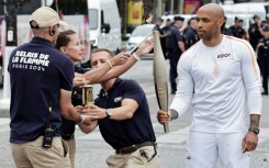 Former Arsenal and France footballer Thierry Henry, the coach of the male French Olympic team, was the first torchbearer 