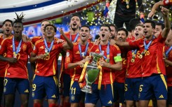 Spain's players celebrate with the Euro 2024 trophy