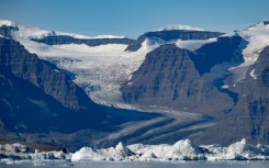 A photograph taken in Scoresby Fjord, Estarn Greenland shows a partly melted glacier