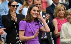 Catherine, Princess of Wales, waves as she takes her seat on Wimbledon's Centre Court 