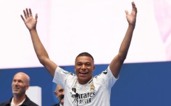 Kylian Mbappe salutes the Real Madrid fans as a former French hero at the club, Zinedine Zidane, looks on