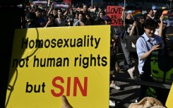 LGBTQ supporters march past anti-gay activists during the annual Pride Parade in Seoul in June