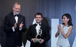 King of Spain Felipe VI (L) and Queen of Spain Letizia present Spain's prestigious Mingote Prize to AFP Palestinian photographer from the Gaza Strip Said Khatib (C), a Palestinian photojournalist from the Gaza Strip