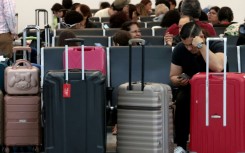 Passengers crowded into airports to wait for news as dozens of flights were cancelled