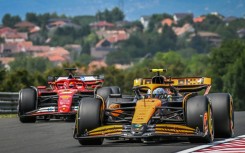 McLaren's British driver Lando Norris (R) at the Hungaroring race track in Mogyorod near Budapest