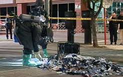 A South Korean Defence Ministry handout picture shows officers in Paju picking through trash sent by balloon from North Korea in early June 2024