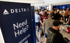 Travelers wait in line at the airport in Los Angeles, California on July 19, 2024 following a global IT crash that hobbled airlines, banks, broadcasters and other businesses