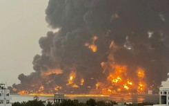 A picture released by the Huthis shows flames and smoke rising over the rebel-held Yemeni port of Hodeida after an Israeli strike