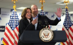 US Vice President Kamala Harris and Second Gentleman Doug Emhoff acknowledge the crowd before Harris spoke at her campaign headquarters in Wilmington, Delaware on July 22, 2024