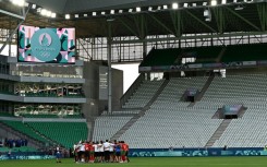 Empty feeling: Morocco's players and staff celebrate at the end of the match with Argentina