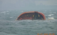 A handout photo from the Philippine Coast Guard shows part of the MT Terra Nova oil tanker after it capsized in Manila Bay