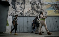 Graffiti depicting liberator Simon Bolivar and Venezuelan late president Hugo Chavez in Caracas in April 2024