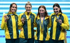 Gold medallists Australia pose with their medals following the women's 4x100m freestyle relay