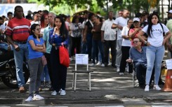 People queue at a polling station in Caracas