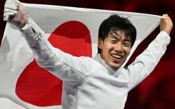 Japan's Koki Kano celebrates winning gold in the men's individual epee