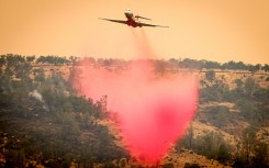 An air tanker drops fire retardant on a ridge as California's Park fire burns on July 27, 2024