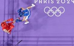 Taiwan's Lin Yu-ting (in red) fights against Uzbekistan's Sitora Turdibekova in the Paris 2024 Olympic Games 
