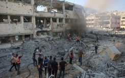 Palestinian rescuers extinguish a fire after Israeli bombardment hit a school complex in the Gaza City area on August 3, 2024