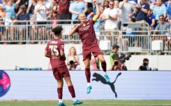 Manchester City forward Erling Haaland, right, celebrates after scoring his second goal against Chelsea in a pre-season English club friendly at Columbus, Ohio