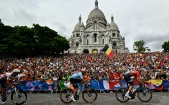 Gold medallist Remco Evenepoel racing past the Sacre Coeur cathedral during the men's cycling road race 
