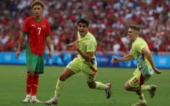 Juanlu Sanchez (C) celebrates with Fermin Lopez after scoring Spain's winning goal against Morocco in their Olympic men's football semi-final