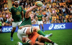 South Africa's Pieter-Steph du Toit (left) looks to offload as he is tackled by Australia's Len Ikitau 