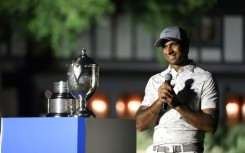 Aaron Rai of England accepts the trophy after winning his first PGA Tour title at the Wyndham Championship