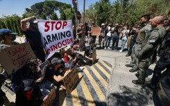 Israeli security force members stand guard during an anti-war sit-in by Israeli left-wing activists, outside the British Consulate General in Jerusalem, with Britain's Foreign Secretary David Lammy expected to arrive for talks