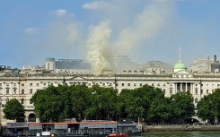 Smoke rises from a fire located in the roof of Somerset House beside the River Thames