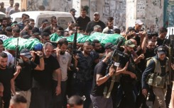 Mourners carry the bodies of two Palestinian Hamas militants killed in an Israeli air strike on Jenin in the occupied West Bank