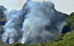 More than 100 firefighters are battling the blaze on two main fronts on the island