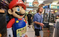 Around 70-80 percent of his customers are foreign tourists, who have flocked to Japan in record numbers this year, says the manager of a vintage video game shop