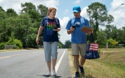 Democratic Party activists Darah Hardy (L) and Yampiere Lugo (R) canvass voters in Laurinburg, North Carolina