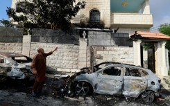 A man points to damage in his house after an attack by Jewish settlers on the Palestinian village of Jit, near Nablus, in the Israeli occupied West Bank 