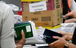  Staff at Guarulhos International Airport group passports of Indian and Vietnamese migrants seeking asylum