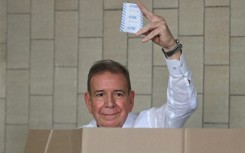 Venezuelan opposition presidential candidate Edmundo Gonzalez Urrutia shows his ballot as he votes in Caracas during the July 2024 presidential election