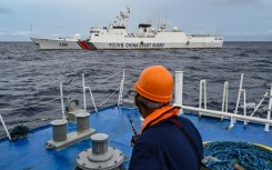 A China Coast Guard ship is seen from a Philippine Coast Guard vessel during a supply mission to Sabina Shoal earlier this month