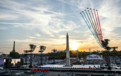 Jets from the French Air Force acrobatic flying team fly over Place de la Concorde during the Paralympics opening ceremony