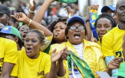 Crowds cheering at a parade to mark the anniversary 