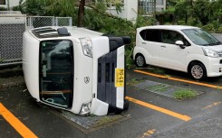 A car overturned by strong winds from Typhoon Shanshan in Miyazaki