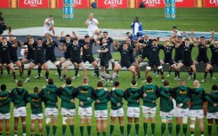 New Zealand players (background) perform the Haka watched by the South African team ahead of a Rugby Championship match in Johannesburg on August 31.
