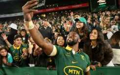 South Africa captain Siya Kolisi takes a selfie with supporters after a 2024 Rugby Championship victory over New Zealand in Johannesburg.