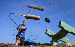 A player splits the wooden end of his stick while striking the hornuss