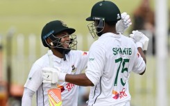 Bangladesh's Mushfiqur Rahim (L) and Shakib Al Hasan celebrate after winning the second Test